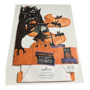 May include: A Hallmark Paper Wonder Halloween card featuring a witch, bats, and an owl. The card has a 3D pop-up design with orange and black colors. The text "Witching You Happy Halloween" is visible on the front.
