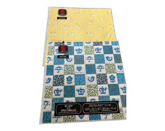 May include: Two sheets of gift wrap. One is yellow with a white teapot pattern. The other is blue with a patchwork design of teapots, umbrellas, and flowers. Each sheet measures 50.8 cm x 76 cm.