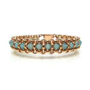 May include: A copper chain bracelet with light blue faceted beads. The bracelet has a magnetic clasp.