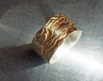 wide silver ring with structure like labyrinth partly gilded wedding ring