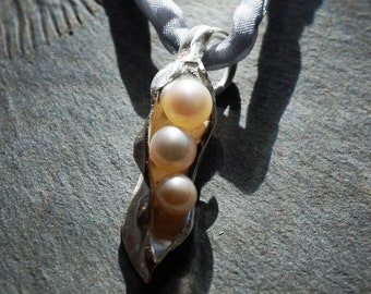 Small silver pendant with three real pearls shaped like a natural pod