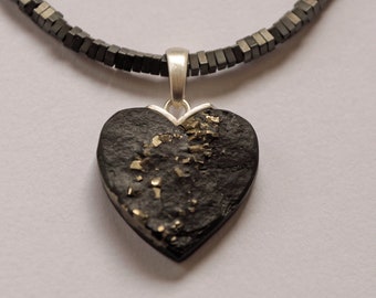 small heart made of slate with glittering pyrite inclusions on hematite necklace