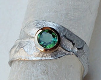Silver ring with green tourmaline in gold frame