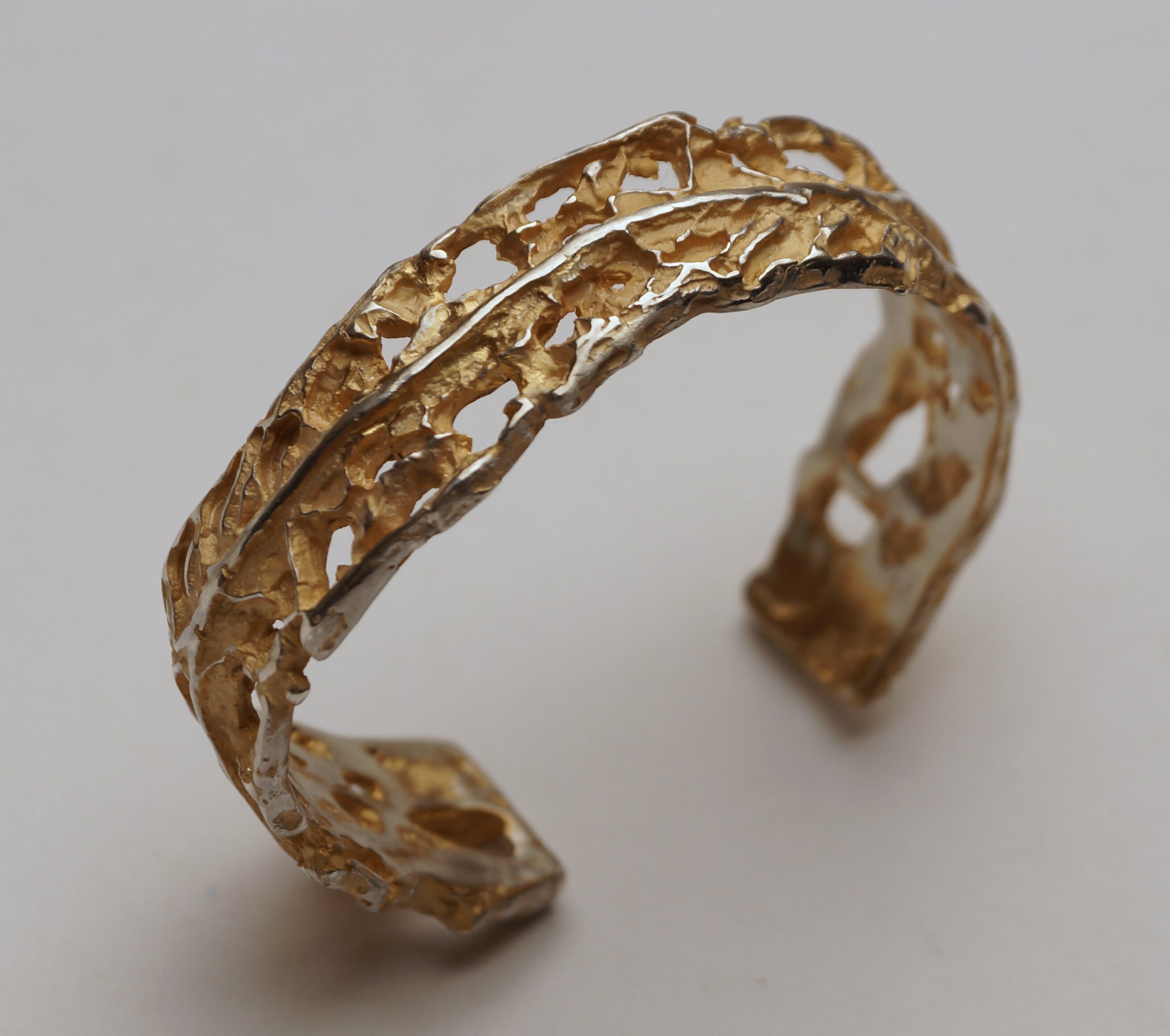 Silver bangle with partial gold plating and interesting wild structures