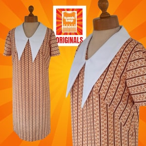 May include: A vintage orange and brown striped dress with a large white Peter Pan collar. The dress has short sleeves and a fitted silhouette.