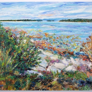 May include: An impressionistic painting of a coastal landscape. The artwork depicts a body of water under a cloudy blue sky, with land masses in the distance. The foreground features colorful vegetation, including green bushes and orange and yellow flowers.
