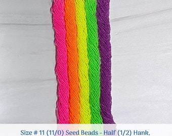 Op de afbeelding: Zes strengen kralen maat 11 in verschillende neonkleuren, waaronder roze, oranje, geel, groen en paars. De kralen zijn verticaal gerangschikt en zijn gelabeld "Size # 11 (11/0) Seed Beads - Half (1/2) Hank, 1 Full Hank, 2 Full Hanks".