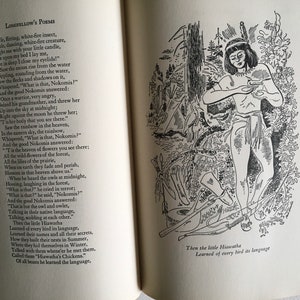 May include: Black and white illustration of a Native American person standing in a forest. The person is holding a small object in their hands. The text "Then the little Hiawatha Learned of every bird its language" is at the bottom of the image.