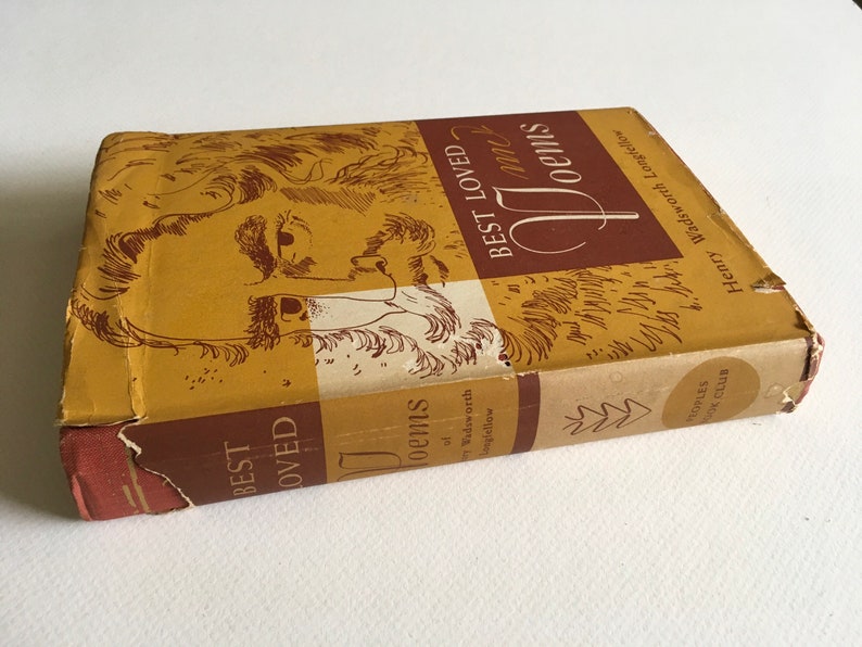 May include: A brown book with a gold cover featuring a black and white illustration of a man's face. The title of the book is "Best Loved Poems" by Henry Wadsworth Longfellow.