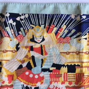May include: A colourful fabric panel with a Japanese-inspired design. The panel features a woman in a traditional costume, surrounded by intricate patterns and symbols. The colours are vibrant and bold, including red, yellow, blue, and white.