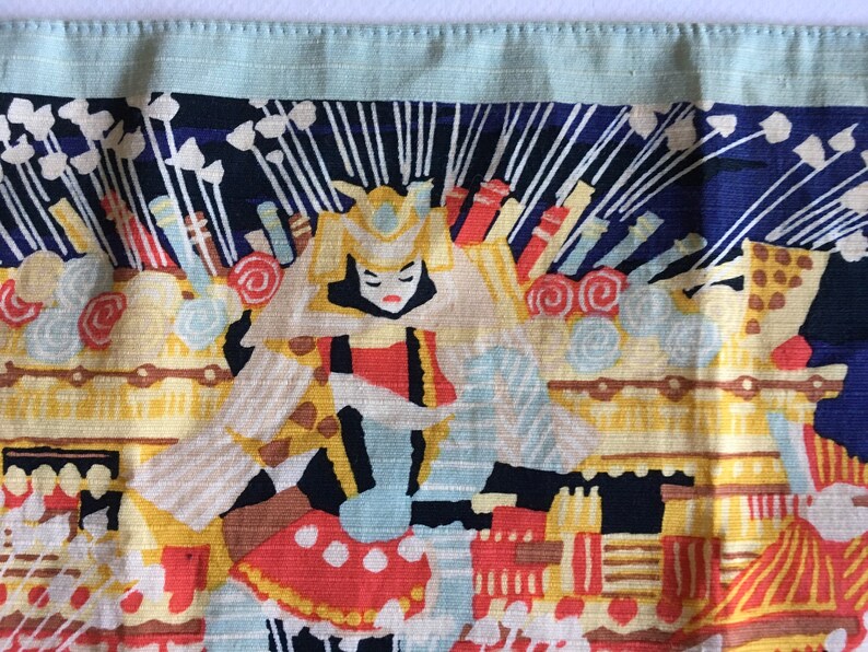 May include: A colourful fabric panel with a Japanese-inspired design. The panel features a woman in a traditional costume, surrounded by intricate patterns and symbols. The colours are vibrant and bold, including red, yellow, blue, and white.