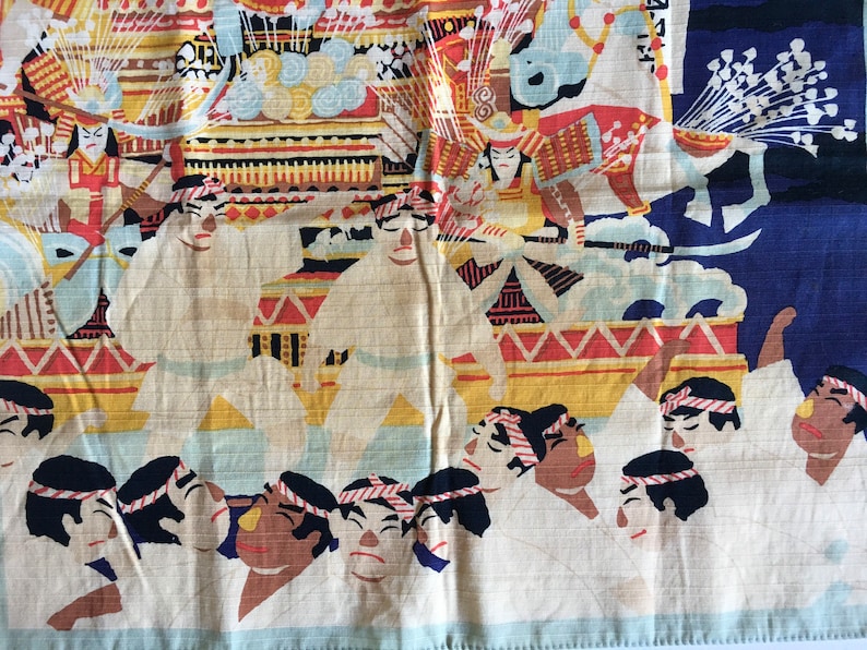 May include: A vintage Japanese fabric panel depicting a colourful procession. The panel features a group of people in white robes, a decorated float, and a figure in red and black armour. The background is a blue sky with white clouds.