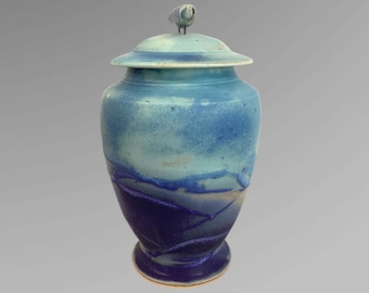 Urn for human beings with handle and  ocean blue colours ,