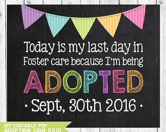 May include: A black chalkboard-style sign with colorful bunting at the top. The text reads: Today is my last day in Foster care because I'm being ADOPTED Sept, 30th 2016. The word ADOPTED is in multi-colored, hatched letters.