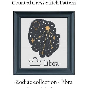 May include: A counted cross stitch pattern of the Libra zodiac sign. The design features a black background with gold stars and the Libra symbol. The text "libra" is written below the design.
