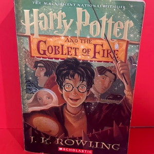May include: A copy of "Harry Potter and the Goblet of Fire" by J.K. Rowling. The cover displays Harry Potter and other characters, with the title text and the words "The Magnificent National Bestseller". Published by Scholastic.