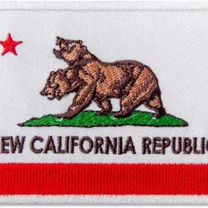 May include: Embroidered patch featuring a brown bear with a red star above it. The text "NEW CALIFORNIA REPUBLIC" is below the bear. The patch has a red stripe at the bottom.
