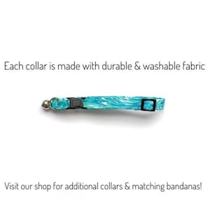 May include: A teal and white patterned cat collar with a black buckle and a silver bell. The text "Each collar is made with durable & washable fabric" is above the collar. The text "Visit our shop for additional collars & matching bandanas!" is below.