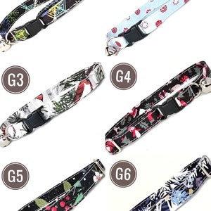 K&ouml;nnte beinhalten: Sechs Katzenhalsb&auml;nder mit verschiedenen festlichen Mustern. Designs umfassen Schneeflocken, Zuckerstangen und Blumenarrangements. Jedes Halsband hat eine schwarze Kunststoffschnalle und eine silberne Glocke.