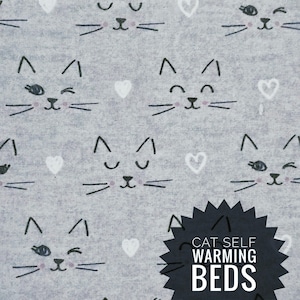 May include: A gray fabric with a repeating pattern of cat faces and white hearts. The cat faces have closed eyes and whiskers. The text "CAT SELF WARMING BEDS" is on a black starburst.
