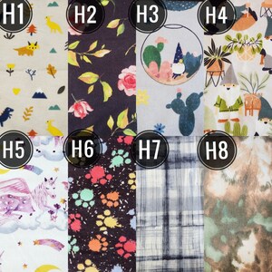 May include: A collection of eight fabric swatches with various patterns. Designs include dinosaurs, floral arrangements, a terrarium with gnomes, gnomes with plants, a unicorn, colorful paw prints, plaid, and a tie-dye effect. The swatches are numbered H1 through H8.