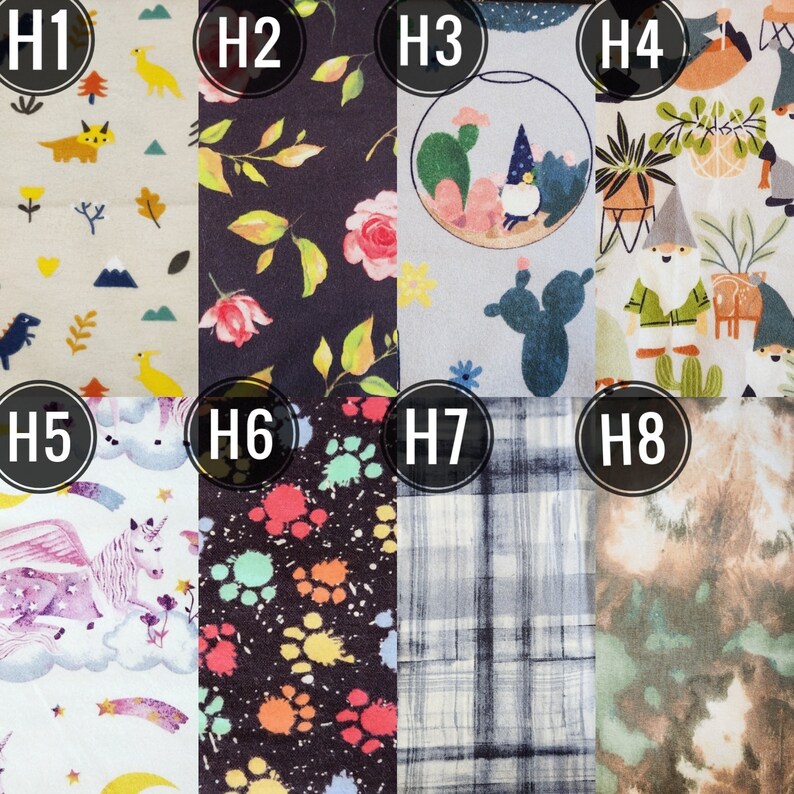 May include: A collection of eight fabric swatches with various patterns. Designs include dinosaurs, floral arrangements, a terrarium with gnomes, gnomes with plants, a unicorn, colorful paw prints, plaid, and a tie-dye effect. The swatches are numbered H1 through H8.