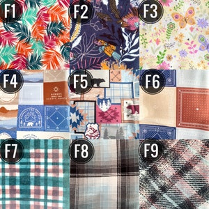 May include: A collection of nine fabric swatches with various patterns. The swatches include tropical leaves, floral designs, and plaid patterns. Some swatches feature text and illustrations, such as bears and arrows. The color palette includes shades of blue, orange, pink, and green.