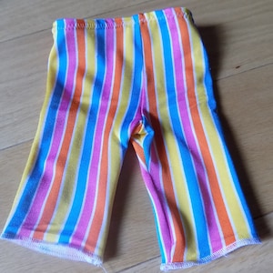 May include: Striped pants in pink, orange, yellow, and blue.