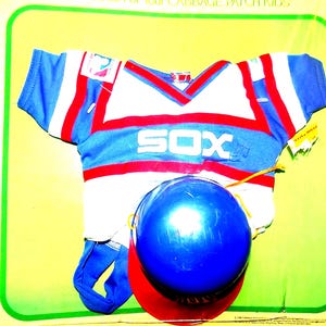 May include: A white, blue and red baseball jersey with the word "SOX" on the front. A blue baseball helmet with a red brim is on top of the jersey.