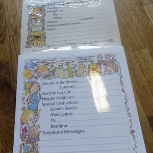 May include: A printable notepad with a colorful cartoon border featuring children and animals. The notepad has lines for writing and includes sections for address, phone number, bedtime, and messages. The text "We are at (address): (phone):" is printed at the top of the notepad.