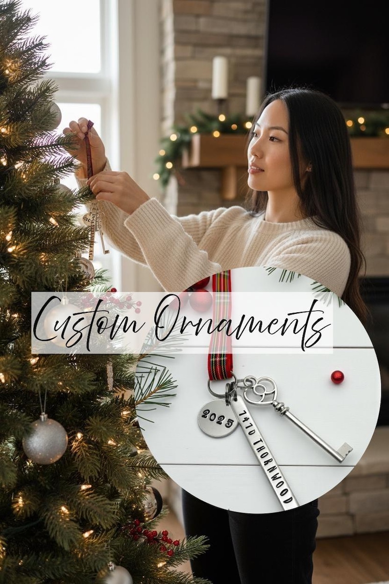 a woman hanging a custom new home ornament on a Christmas tree. Has an insert photo of a custom new home ornament with a long silver tag with the street address hand stamped, a circle tag with the current year the home was purchased, a silver skeleton key, and a tartan ribbon