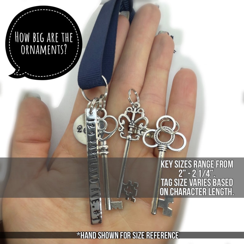 a hand holding silver antique skeleton keys to show the size reference, shows 3 different styles of skeleton keys