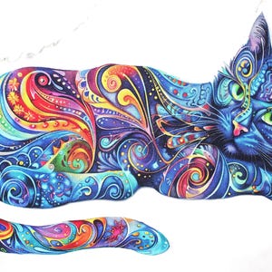 May include: A vibrantly colored illustration of a cat in a relaxed pose. The cat's fur is a deep blue, adorned with intricate patterns in shades of red, orange, yellow, green, and purple. The cat has green eyes and a pink nose, set against a white background.