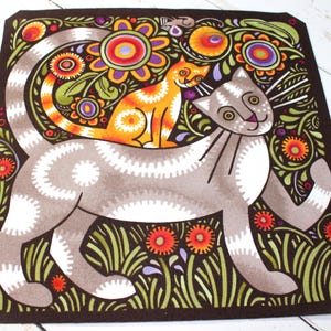 May include: A colorful illustration of two cats in a garden setting. The larger cat is gray with white markings and has a playful expression. The smaller cat is orange with black stripes and is sitting on the larger cat's back. The background is filled with green leaves, flowers, and swirls.