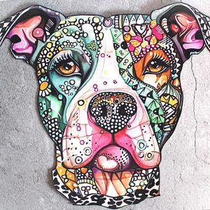 May include: A colorful, stylized illustration of a dog's face. The artwork features intricate patterns and vibrant colors, including pink, green, yellow, and orange. The dog's eyes are brown, and the overall design is detailed and eye-catching.