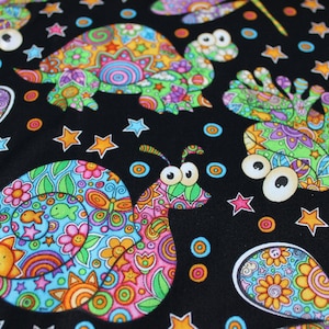 May include: Black fabric with a colorful, whimsical pattern featuring a snail, a turtle, and a dragonfly. The design is filled with swirls, stars, and flowers.