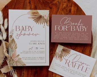 May include: A set of three cards for a baby shower. The main card is a light pink and cream invitation with a floral design and the text "Baby Shower" in a pink arch. The second card is a light pink card with the text "Books for Baby" in white. The third card is a cream card with the text "Diaper Raffle" in pink.