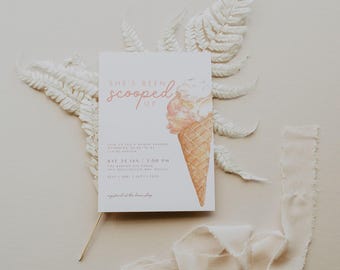 May include: A white card with pink text that reads "She's Been Scooped Up" with a watercolor illustration of an ice cream cone. The card is an invitation to a baby shower on Saturday, January 24th at 2:00 PM. The location is The Carlton Residence, 5412 Washington Way, Dallas, RSVP to Sarah at 555-1212.