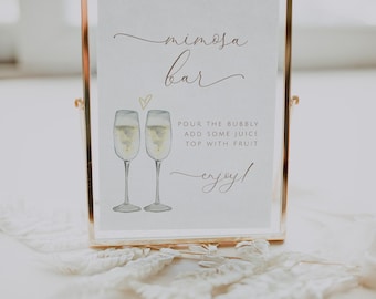 May include: A gold-framed sign with the text "mimosa bar" in cursive script. The sign also includes a watercolor illustration of two champagne flutes and the instructions "Pour the bubbly, add some juice, top with fruit, enjoy!"