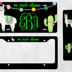 May include: Black license plate frame with a white llama and green cactus design. The text "no prob-llama" is written on the frame. The frame comes with a matching seatbelt cover.