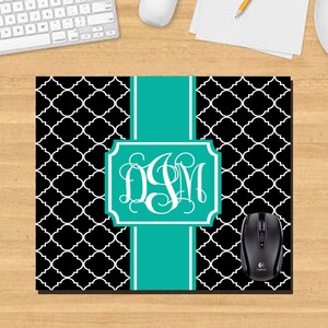 May include: Black and white patterned mouse pad with a teal monogram in a decorative frame. The monogram reads "DSM".