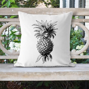 May include: A white throw pillow with a black and white illustration of a pineapple on it.