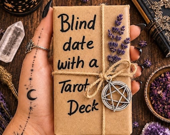 May include: A rectangular tarot deck wrapped in brown paper with the text Blind date with a Tarot Deck printed in black. The package is tied with twine, decorated with a sprig of dried lavender, and features a silver pentacle charm.