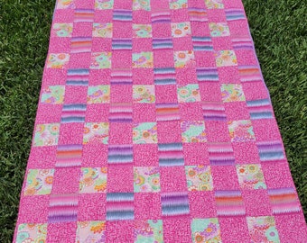 Pastel pink quilt in Kaffe Fassett Collective fabrics , checked pattern.  45 x 64 inches.