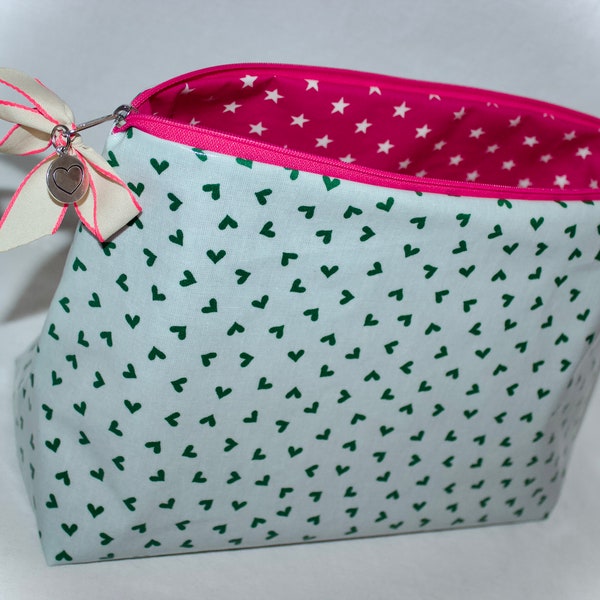 Cute oilcloth toiletry bag from Au Maison with hearts in green and neon pink