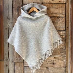 Grey wool blanket poncho cape hooded with fringes Light grey lambswool ladies poncho cape with fringes and hood Wool blanket poncho cape