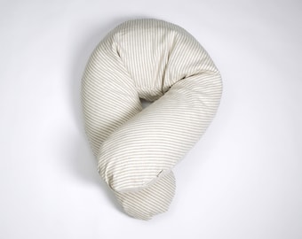May include: A beige and white striped pregnancy pillow shaped like a U. The pillow is designed to provide support for pregnant women during sleep and while breastfeeding.