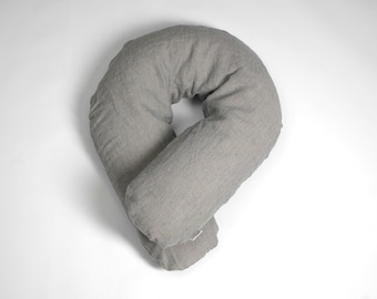 May include: A gray U-shaped pregnancy pillow with a textured fabric cover.