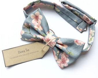 Mens cherry blosom bow tie, in bluey grey linen with a pink floral print.