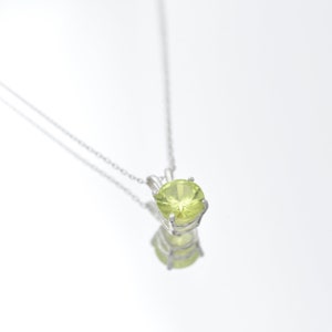 Peridot Necklace - A round silver solitaire Peridot pendant necklace, set in a sturdy sterling silver bail with a sterling silver necklace. A stone that gleams.